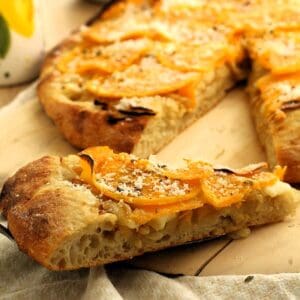 Slice of pizza with butternut squash topping.