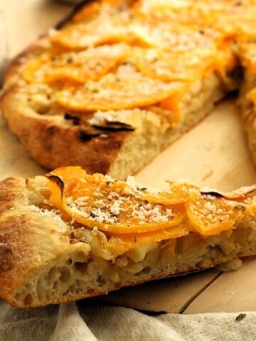 Slice of pizza with butternut squash topping.