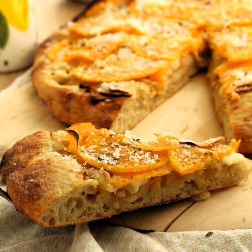 Slice of pizza with butternut squash topping.