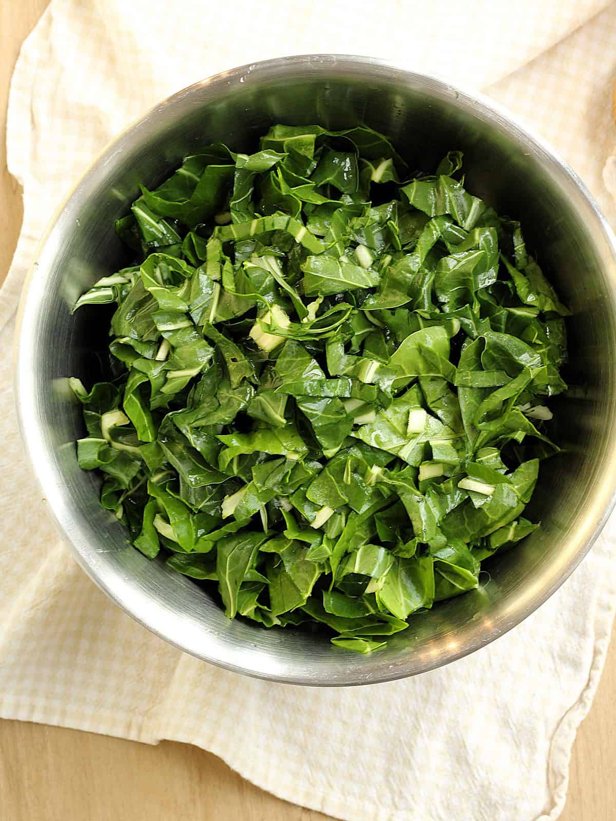 Swiss chard cut into ribbons in bowl.