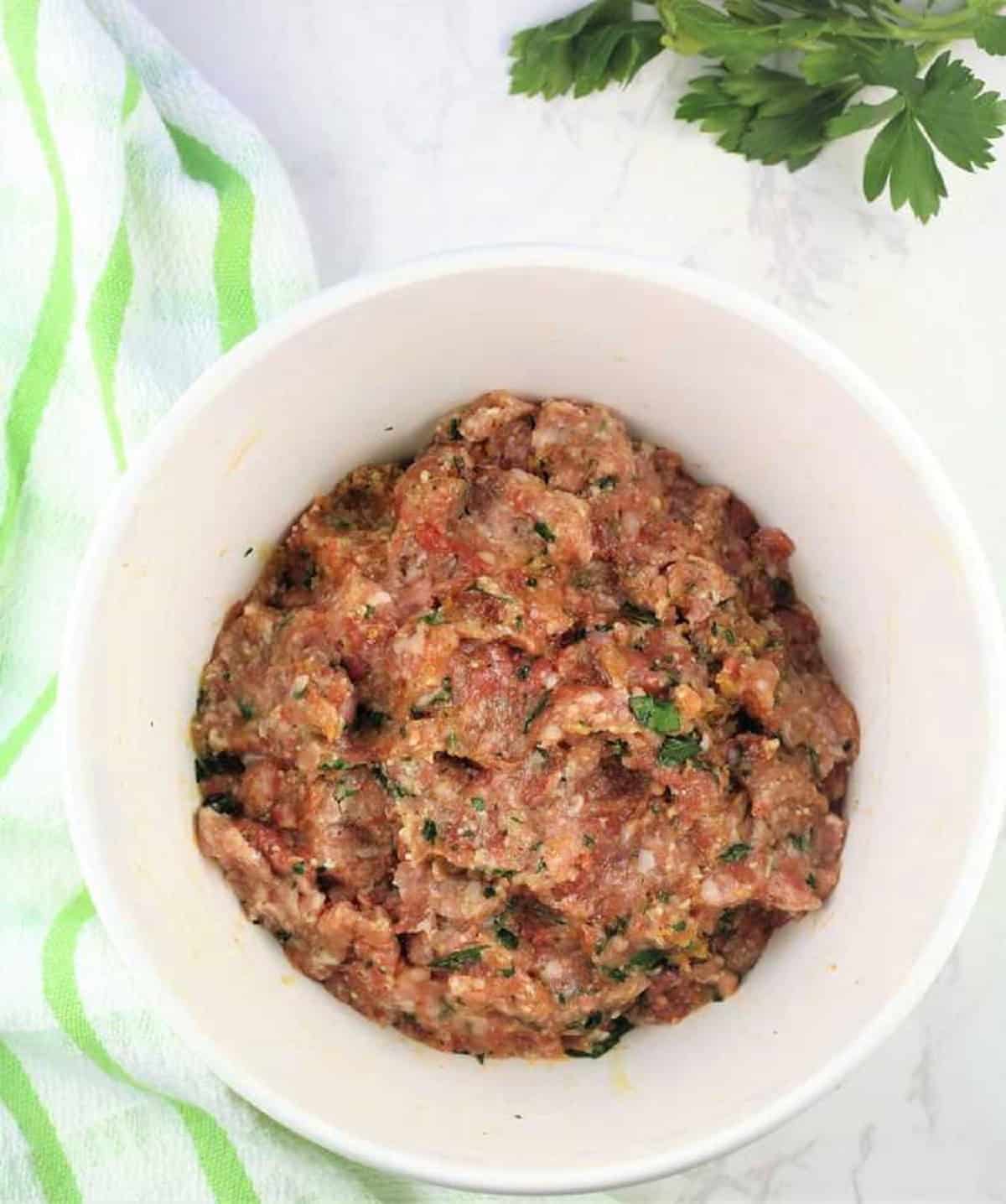 Raw meatball mixture in bowl for tiny meatball soup recipe.