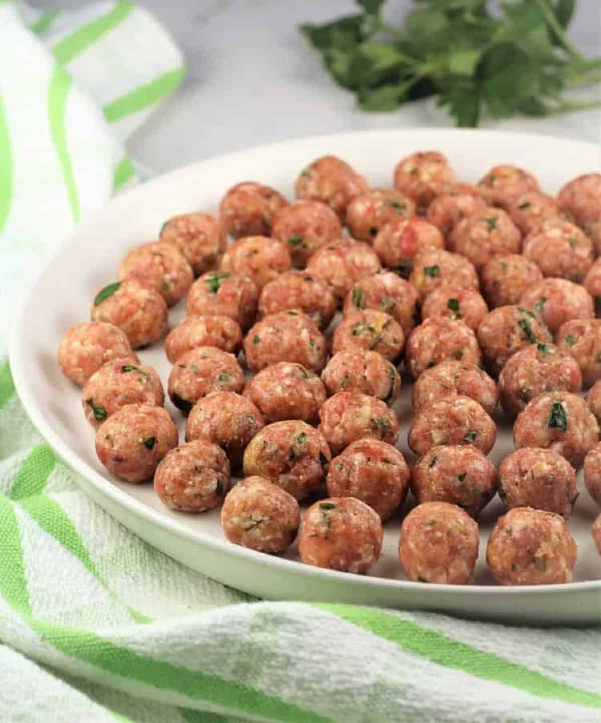 Tiny meatballs for pastina soup resting on plate.